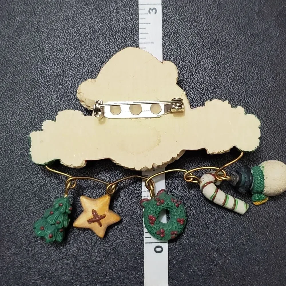 Charm holding Santa holiday brooch